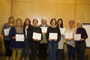 adults holding certificates